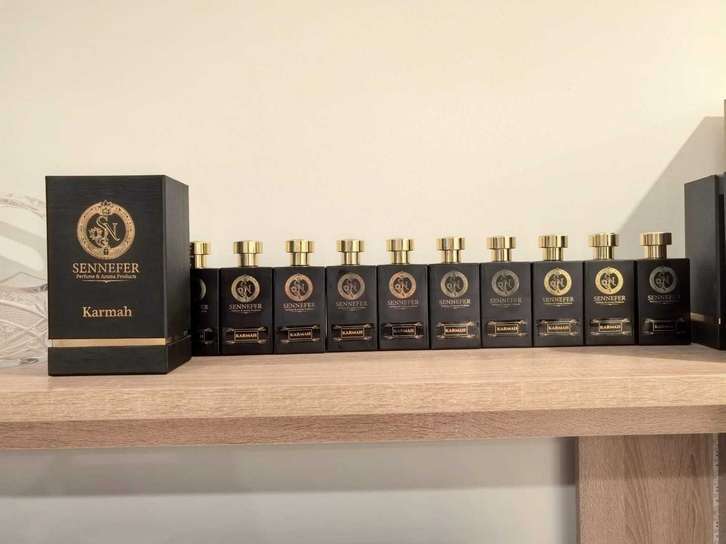 The full SENNEFER Karmah extrait collection lined up beside its presentation box