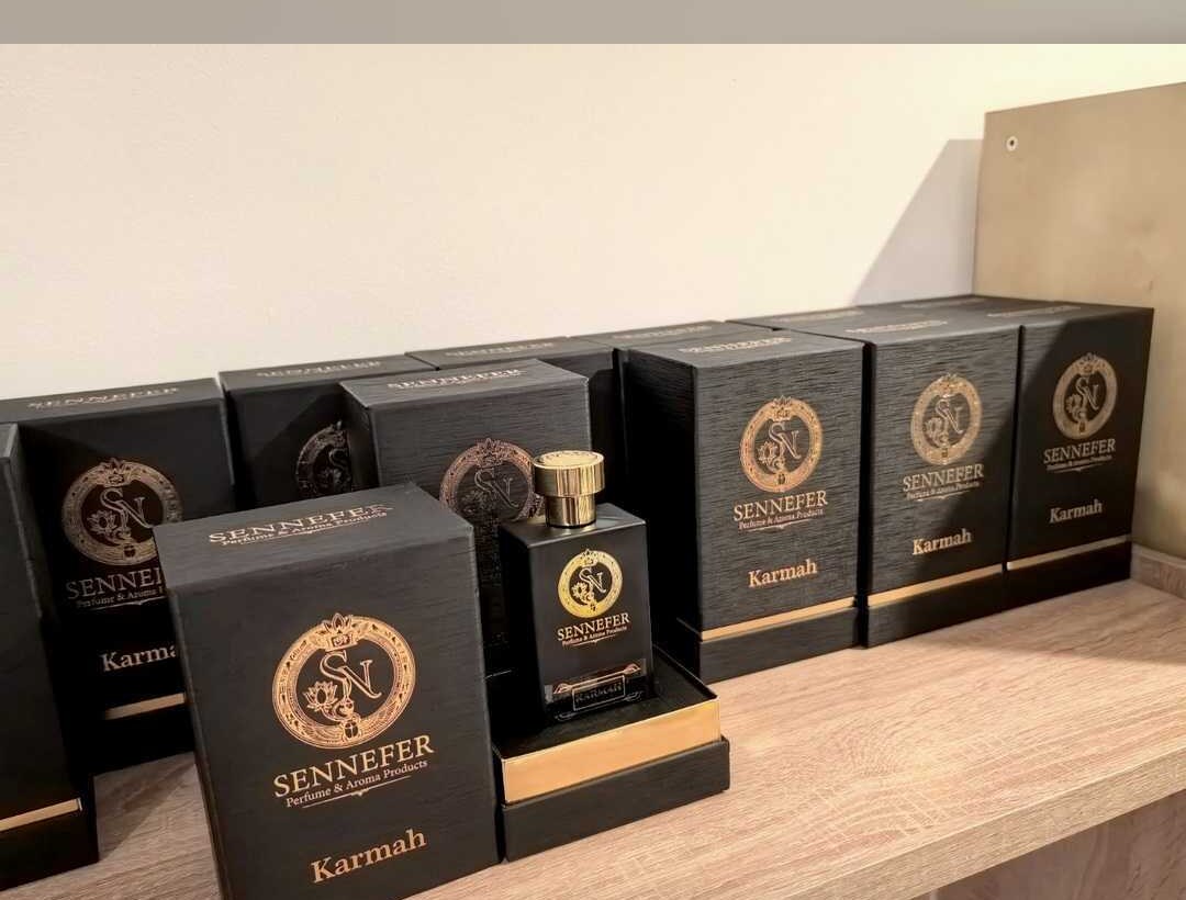 SENNEFER Karmah bottle and boxes arranged on a wooden shelf