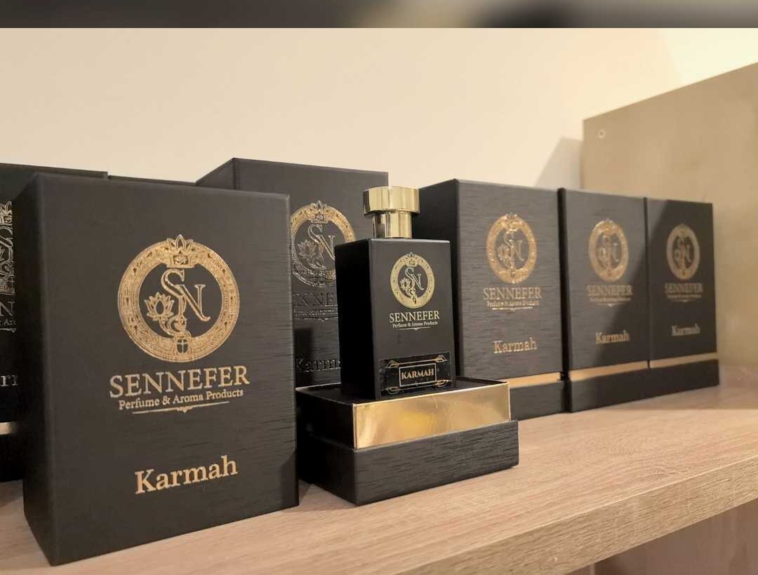 A SENNEFER Karmah bottle resting in its gold-lined presentation box