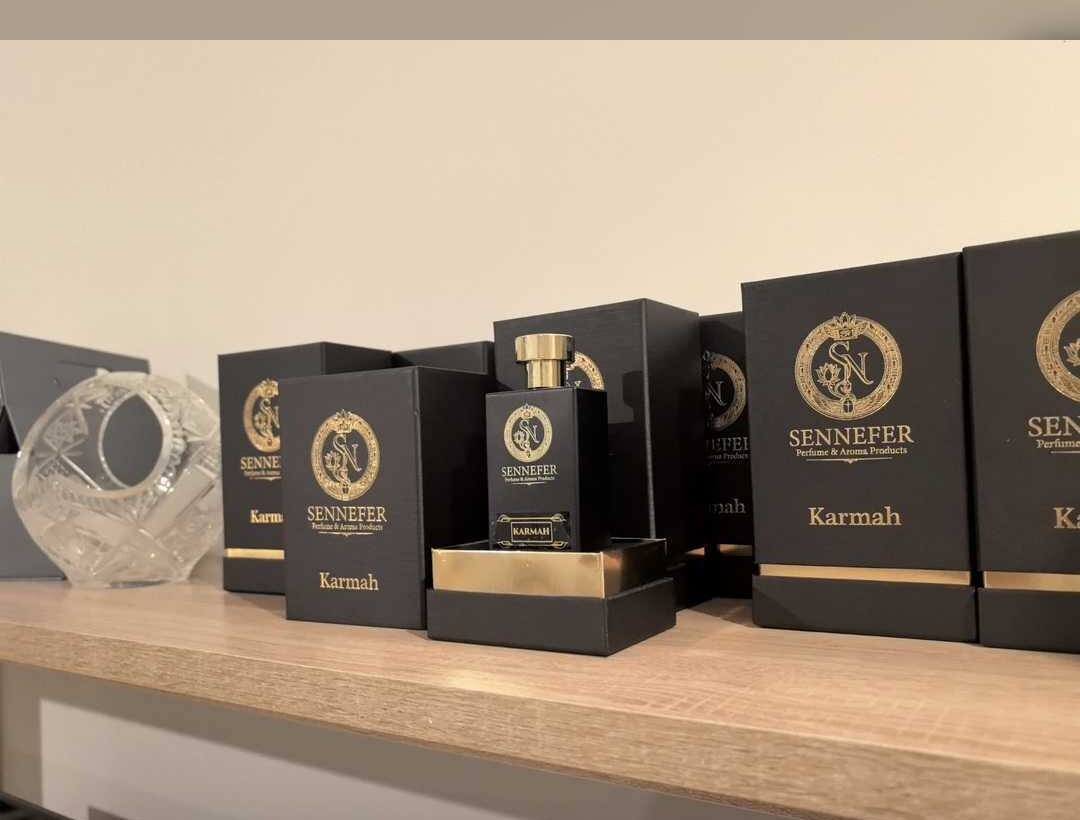 SENNEFER Karmah boxes arranged around the signature bottle