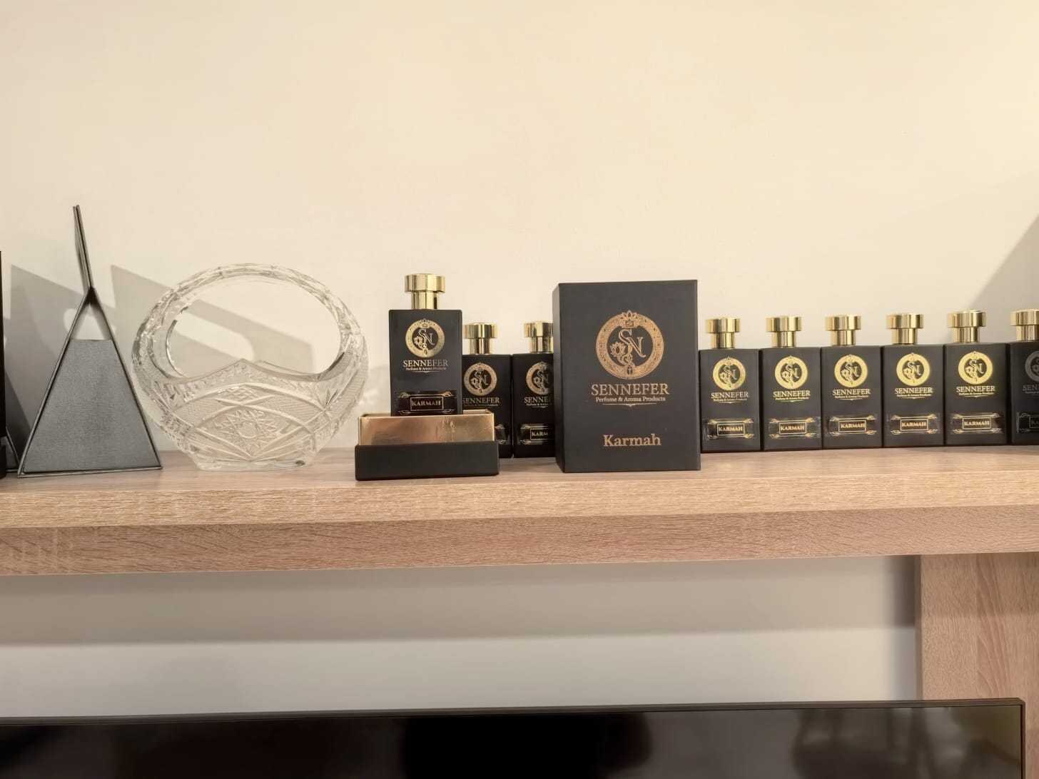 SENNEFER Karmah bottles and box styled beside a cut-crystal bowl