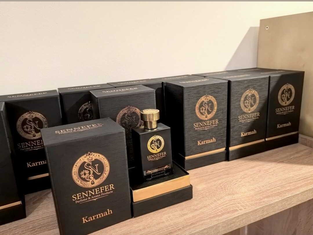SENNEFER Karmah boxes arranged on a shelf around the signature bottle