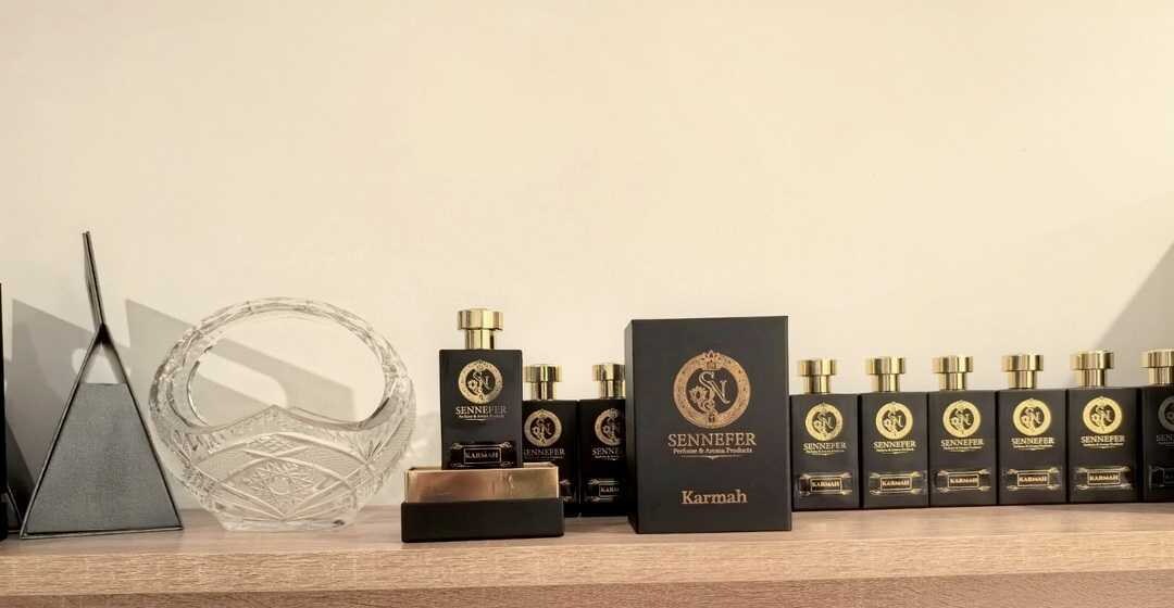 SENNEFER Karmah bottles lined along a shelf beside crystal accent pieces